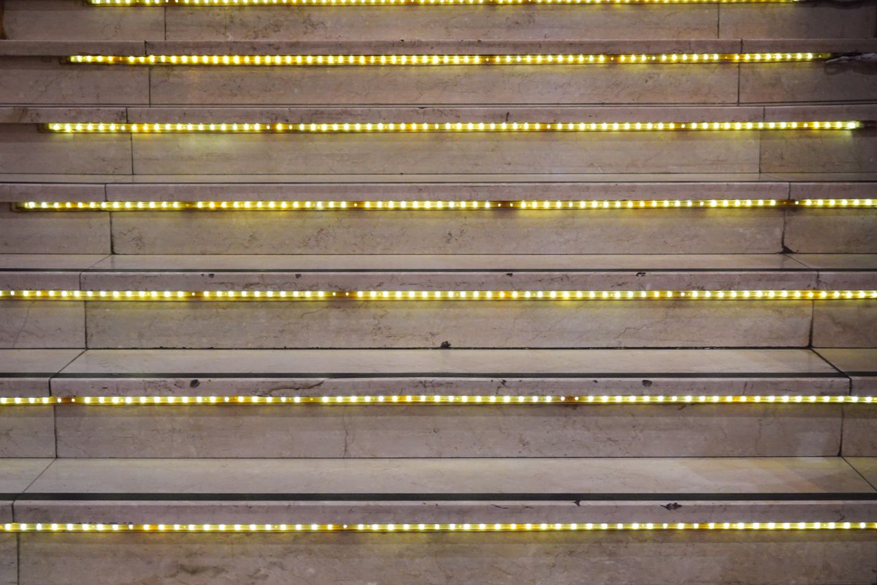 The Art of Drawing Readers In: Your attractive post title goes here Close-up of a staircase with glowing LED lights on each step, creating a modern look.